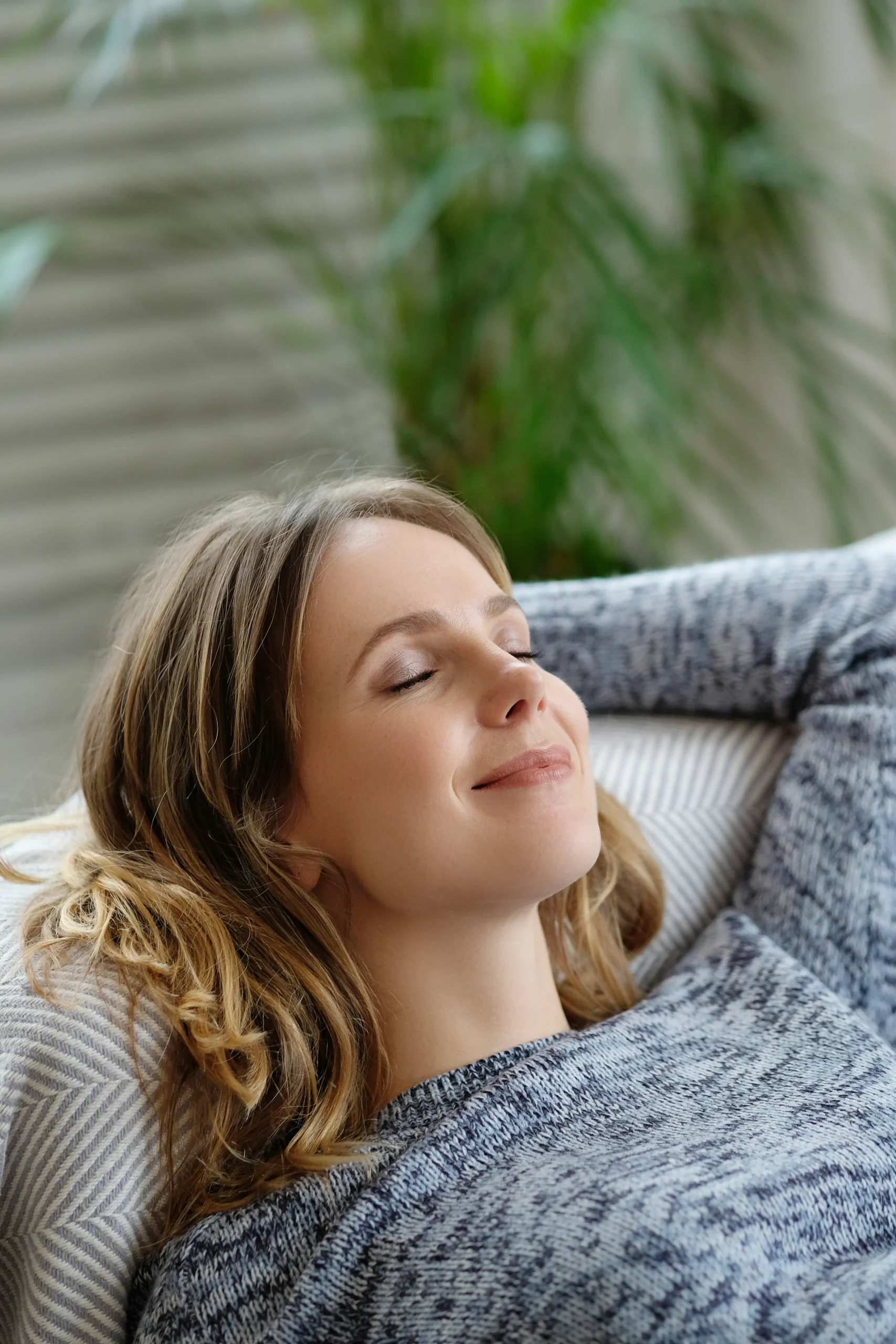 woman-relaxing-on-couch-with-eyes-closed-2026-01-09-10-43-09-utc